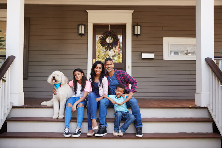 Family walking up steps to their new home